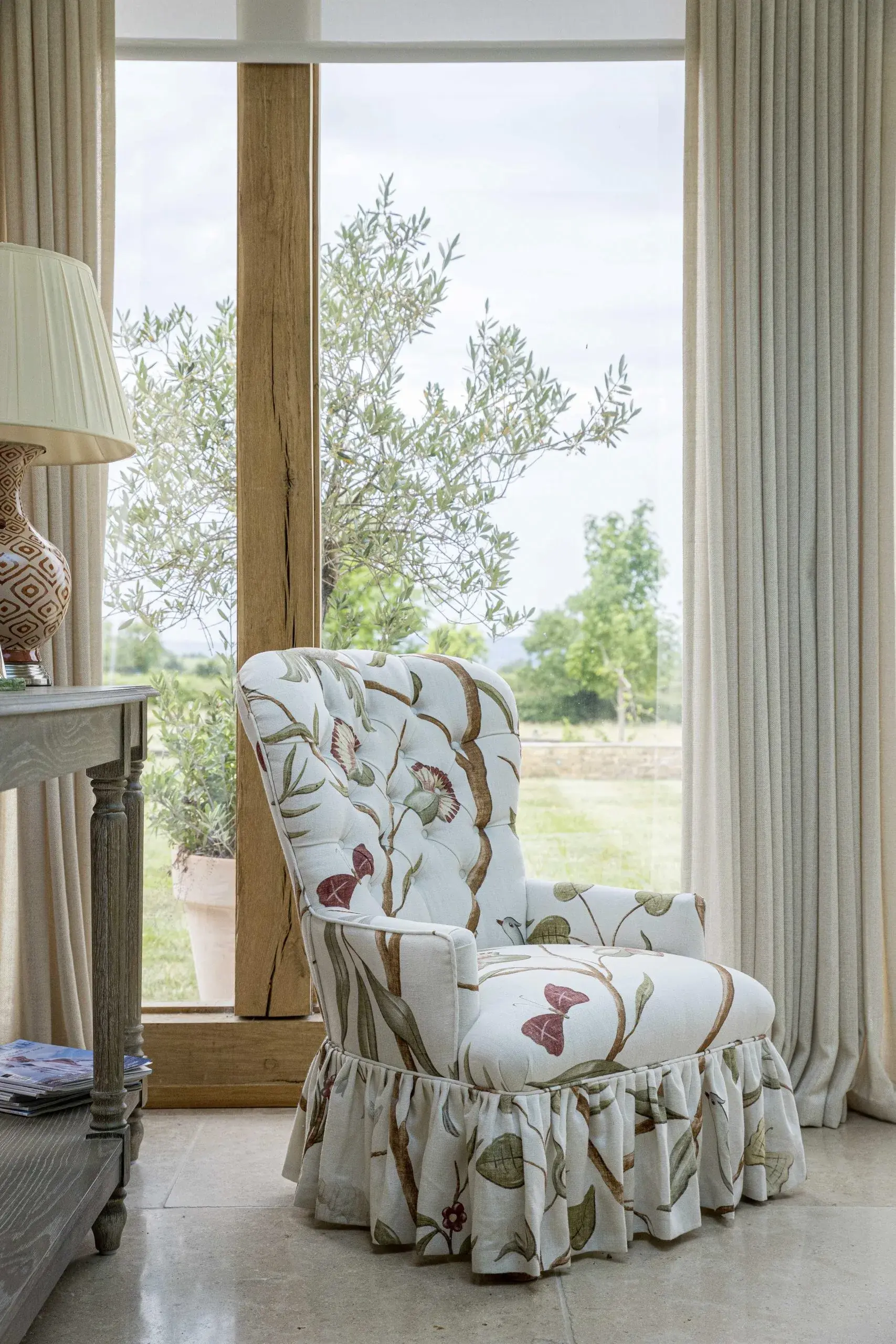 Floral chair by floor-to-ceiling window